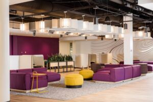 An open space with purple and yellow seating and tables