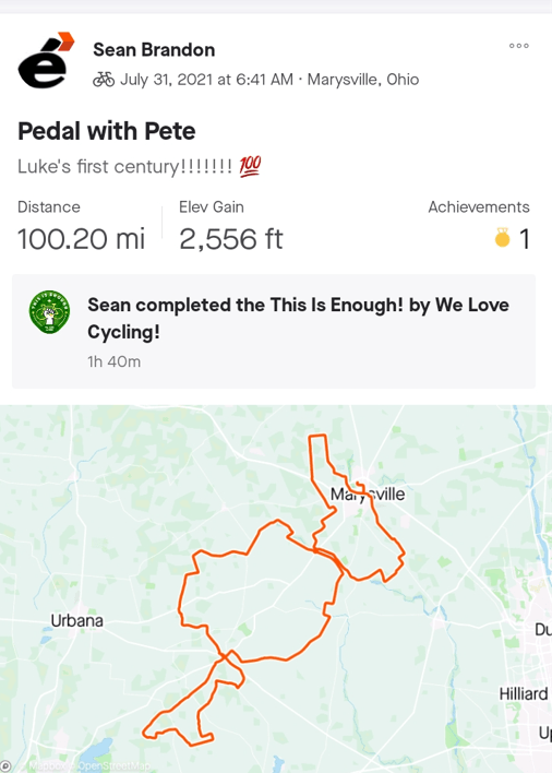 A screenshot from a mobile app that depicts a map of a bike ride. Text reads "Pedal with Pete," "Luke's first century!," "Distance: 100.20 mi," "Elev Gain: 2,556 feet," and the caption "Sean completed the This Is Enough! by We Love Cycling! 1h 40m"